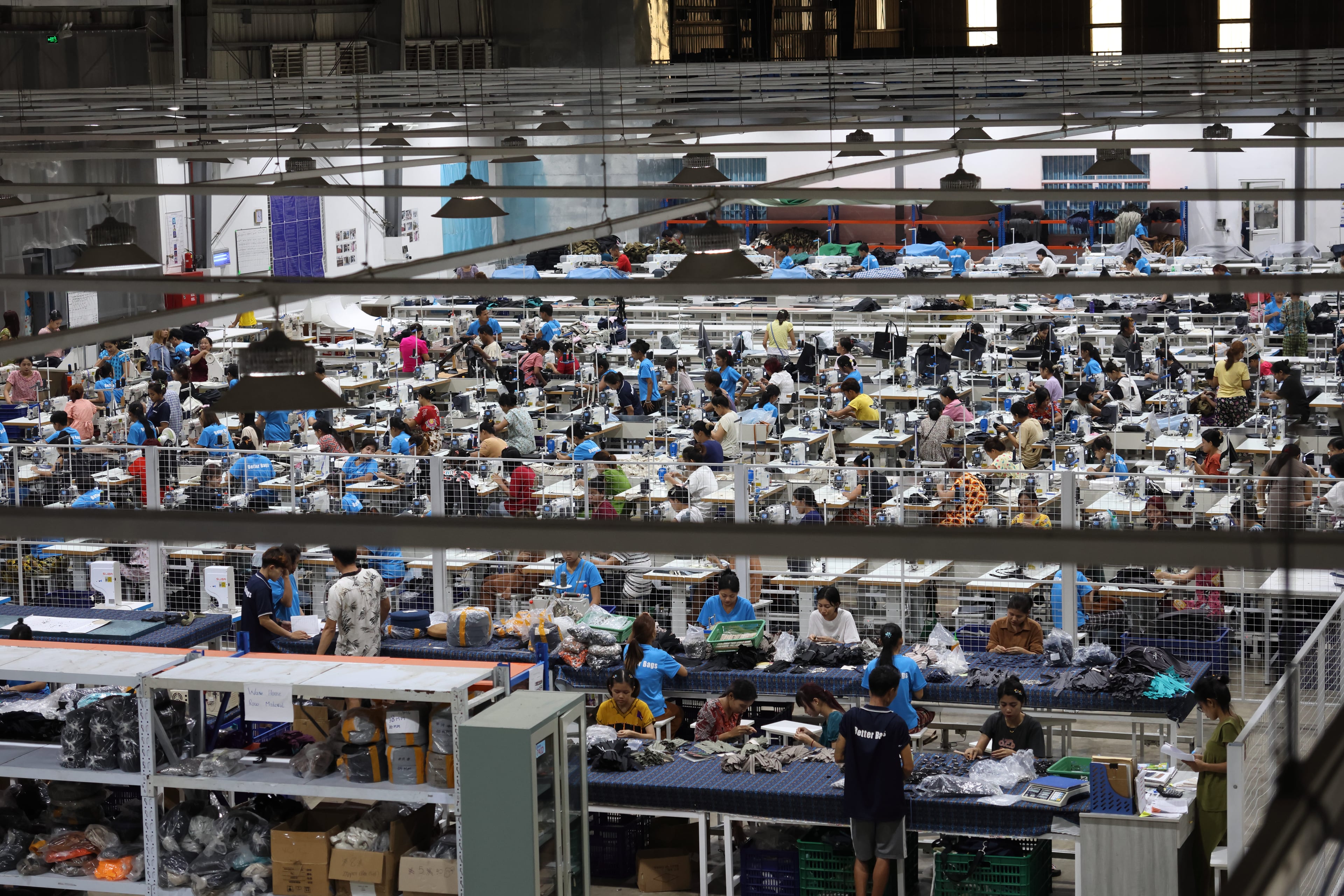 Looking down on the main sewing floor from above. The preparation group is in the foreground; the sewing lines are behind.